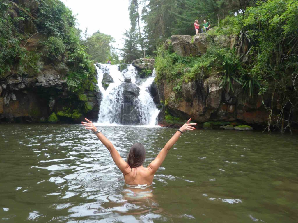 Swimming at a water fall in day trip in Arusha
