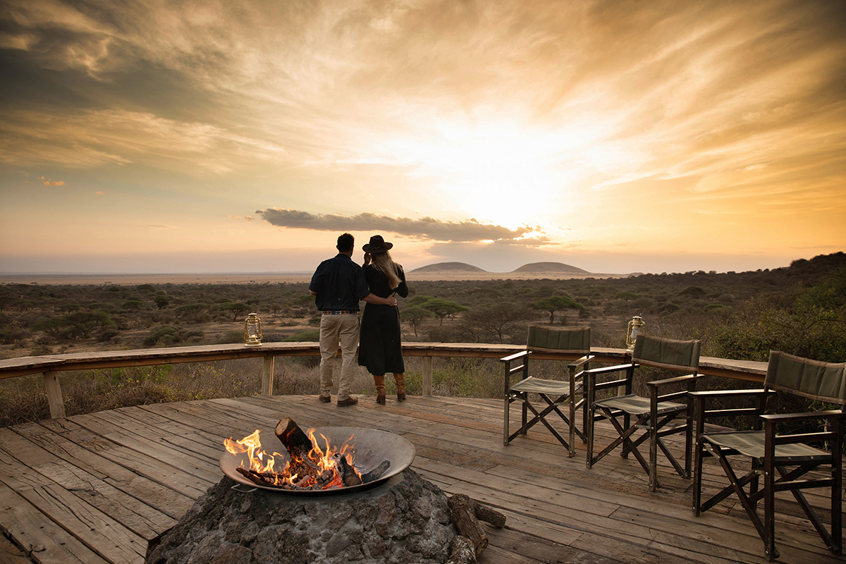 Couple enjoy sunset in the serengeti