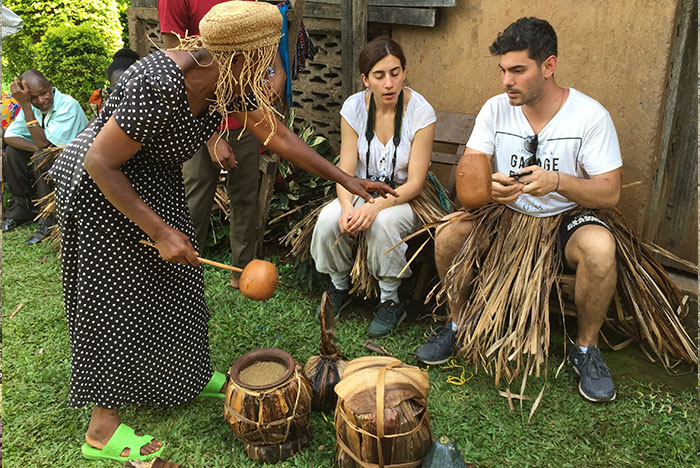 Tourists enjoying the local beer from a local Chagaa woman